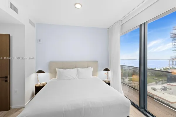 a bedroom with a bed and painting on the wall