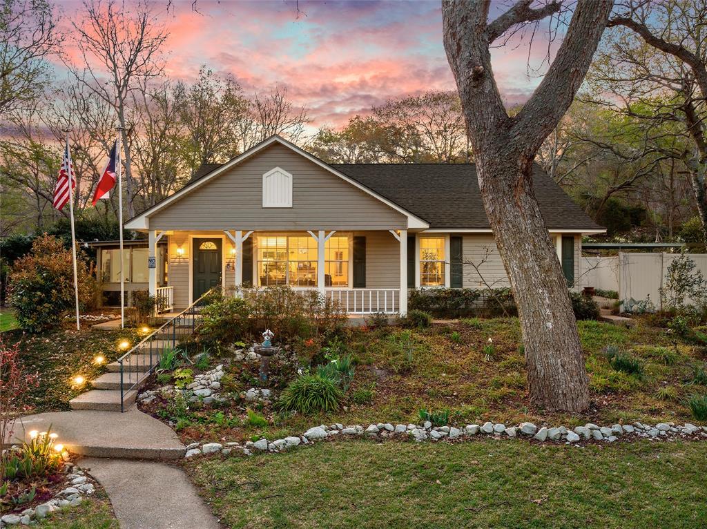 a front view of a house with garden