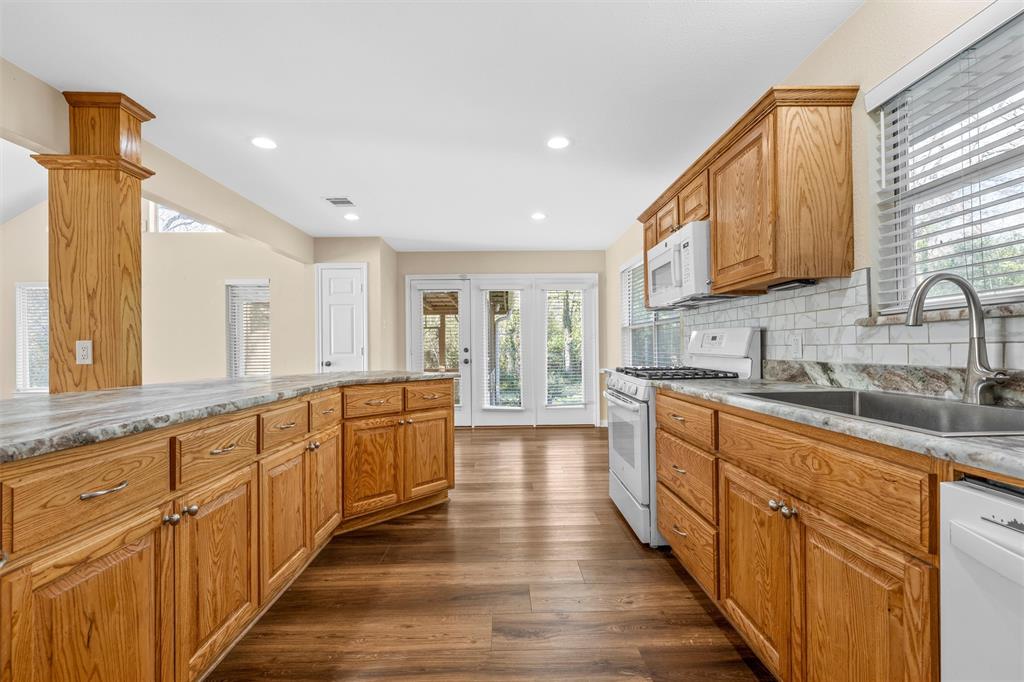 4505 Shady Glen Drive Waco, TX 76708 - Photo 12 of 40 a large kitchen with stainless steel appliances lots of counter space and wooden floor