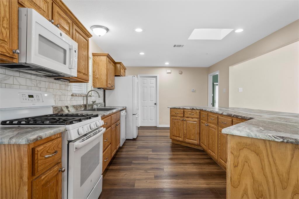 4505 Shady Glen Drive Waco, TX 76708 - Photo 13 of 40 a large kitchen with stainless steel appliances granite countertop a stove and a sink