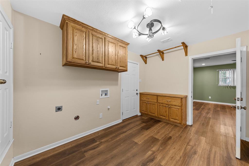 4505 Shady Glen Drive Waco, TX 76708 - Photo 17 of 40 a room with wooden floor and cabinets