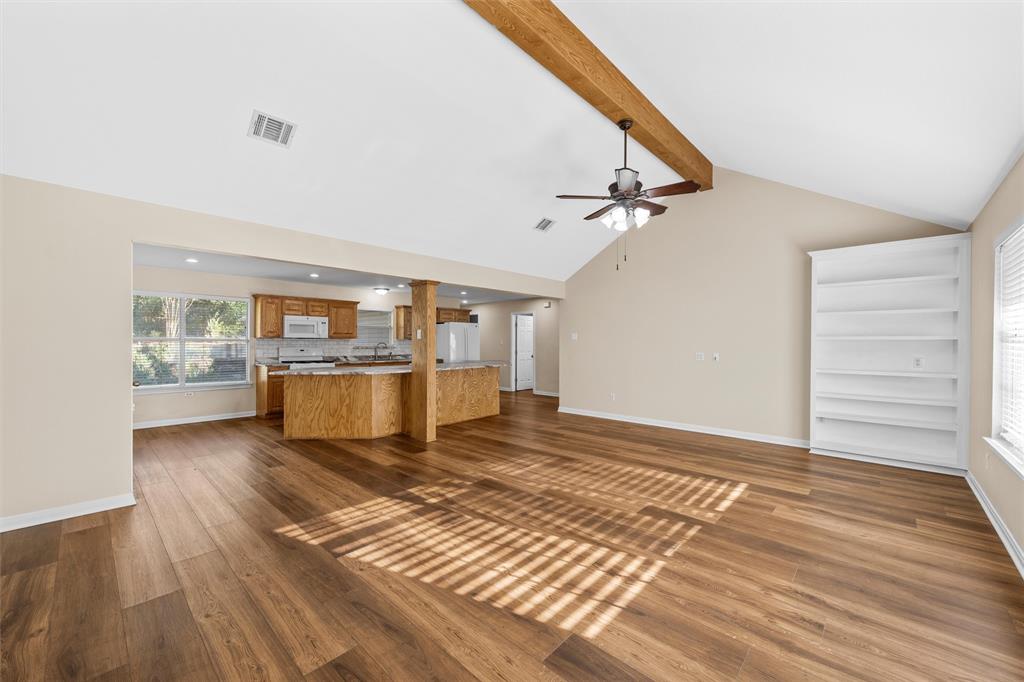 4505 Shady Glen Drive Waco, TX 76708 - Photo 8 of 40 a view of a living room with kitchen island wooden floor and a ceiling fan