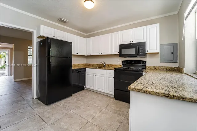 a kitchen with a refrigerator sink and stove