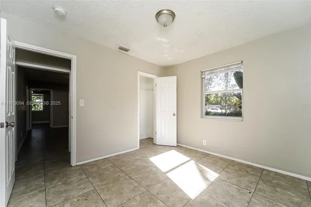 a view of livingroom with hallway window and stairs