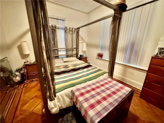 a bedroom with a bed and a mirror