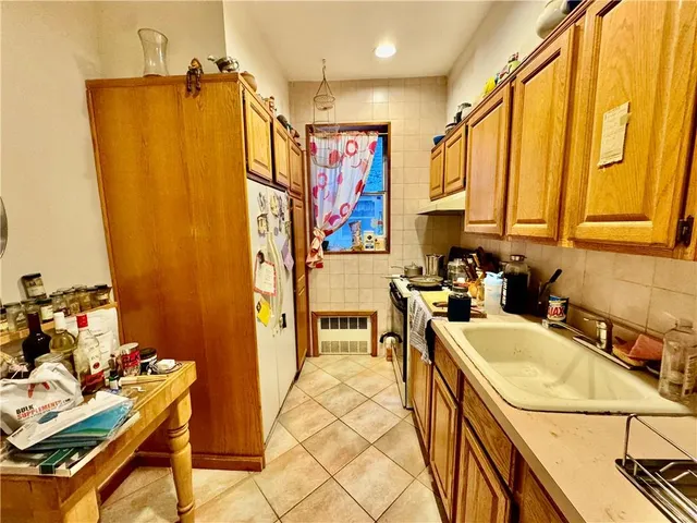 a view of a kitchen with a sink and cabinets