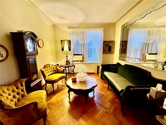 a living room with furniture and a lamp