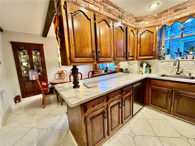 a kitchen with a sink and a refrigerator