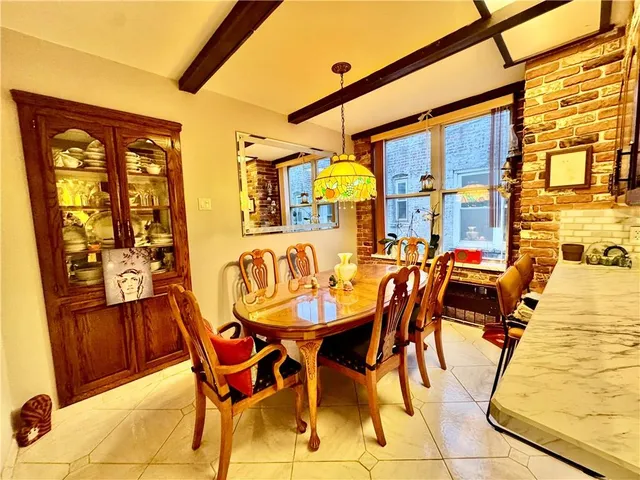 a view of a dining room with furniture and a window