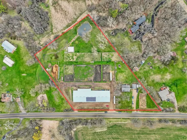 an aerial view of a houses with a yard