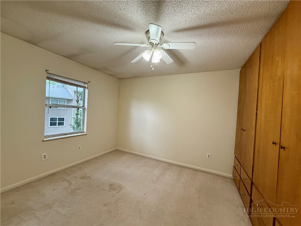 229 East King Street, Unit 30 Boone, NC 28607 - Photo 15 of 19 an empty room with windows and fan