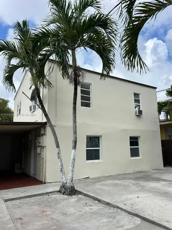 a view of a house with a house with a palm tree