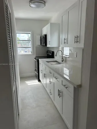 a kitchen with stainless steel appliances granite countertop a sink and a stove top oven