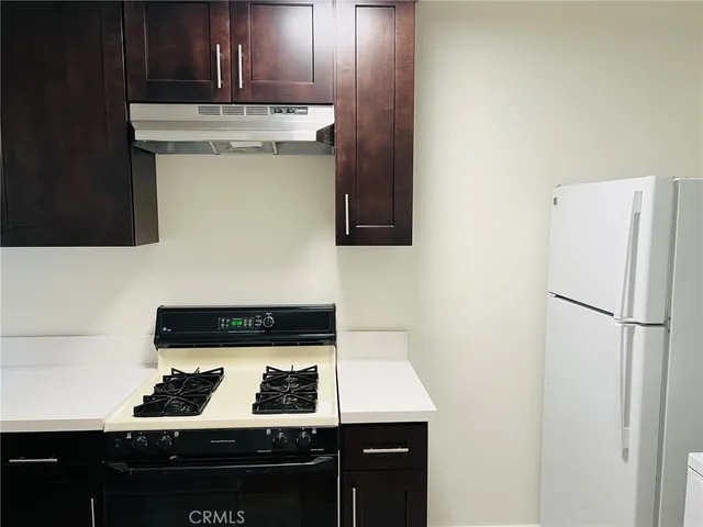 a bathroom with a sink a toilet a mirror and shower