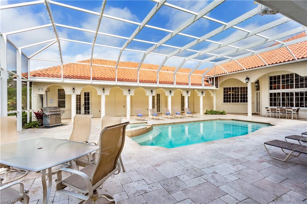 2225 23rd Street Southwest Naples, FL 34117 - Photo 16 of 44 a swimming pool with outdoor seating and yard