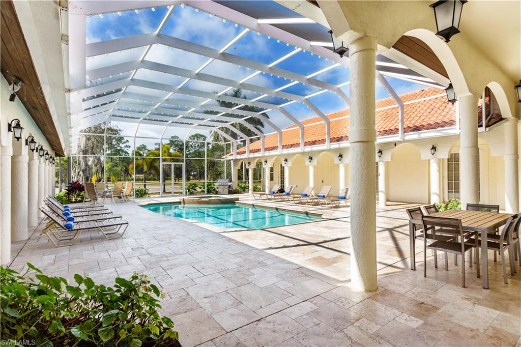 2225 23rd Street Southwest Naples, FL 34117 - Photo 17 of 44 a view of a patio with a table and chairs and potted plants
