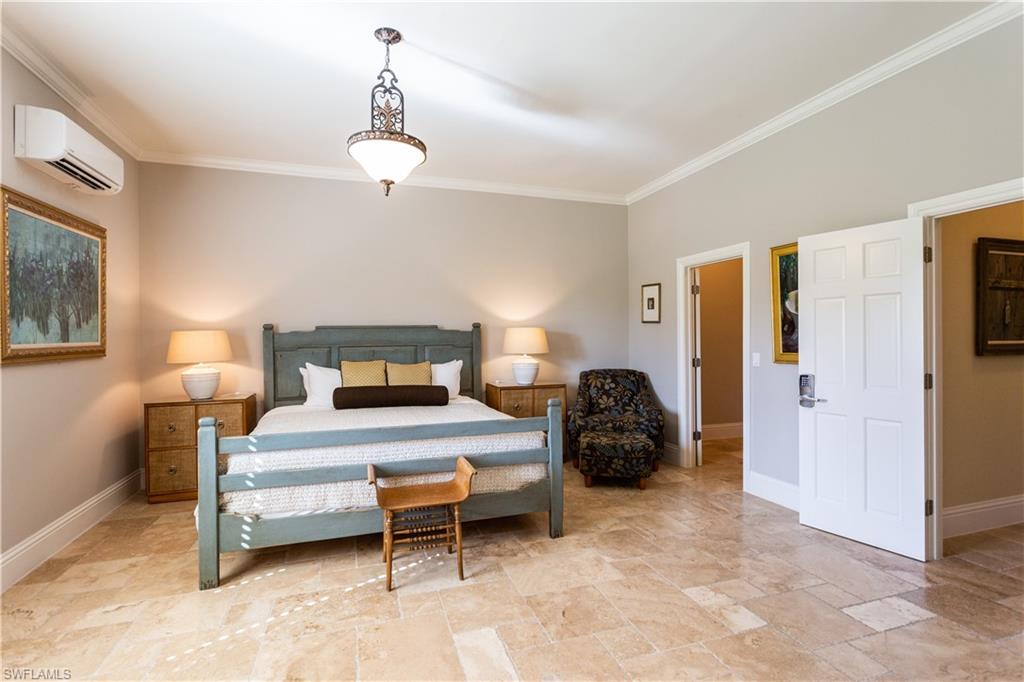 2225 23rd Street Southwest Naples, FL 34117 - Photo 18 of 44 a bedroom with a bed and a lamp