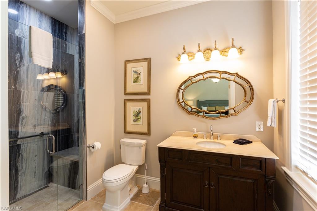2225 23rd Street Southwest Naples, FL 34117 - Photo 19 of 44 a bathroom with a sink vanity mirror and toilet