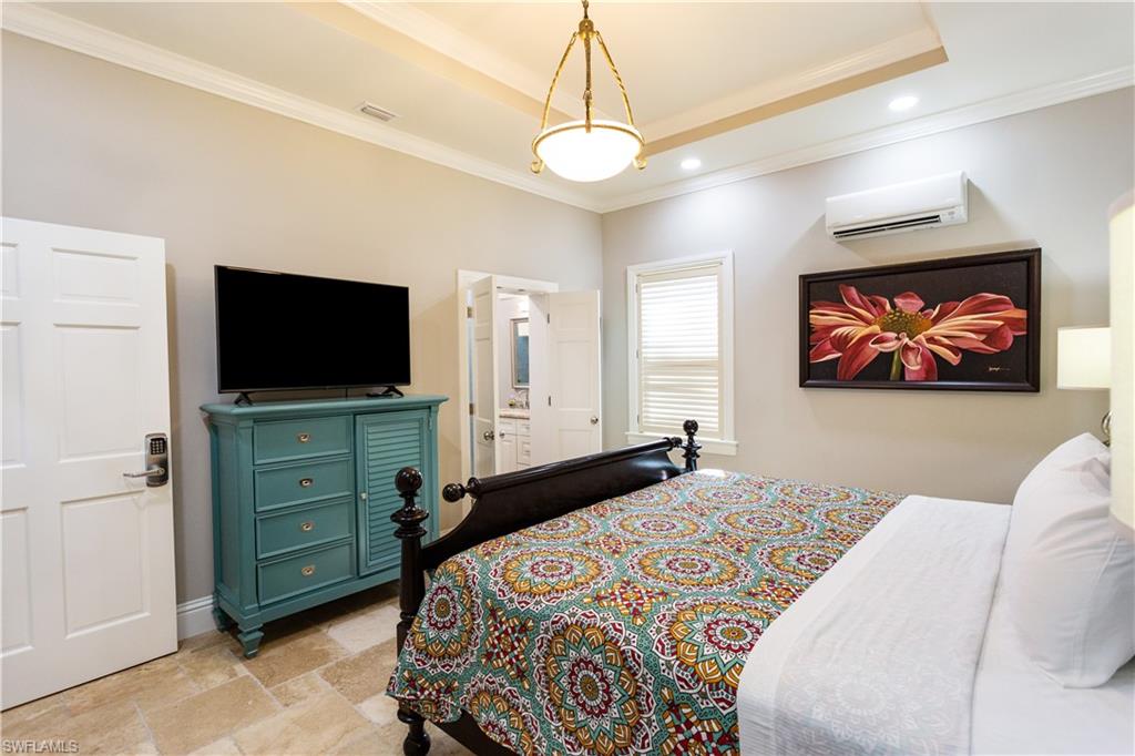 2225 23rd Street Southwest Naples, FL 34117 - Photo 22 of 44 a bedroom with a bed and a flat screen tv