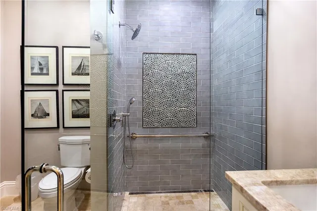 a bathroom with a granite countertop shower sink and mirror