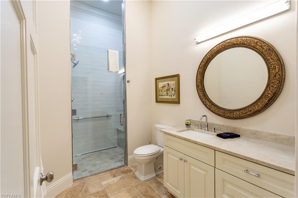 2225 23rd Street Southwest Naples, FL 34117 - Photo 28 of 44 a bathroom with a toilet a sink and a mirror