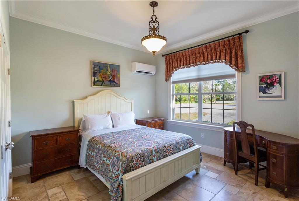 2225 23rd Street Southwest Naples, FL 34117 - Photo 32 of 44 a bedroom with a bed and a window