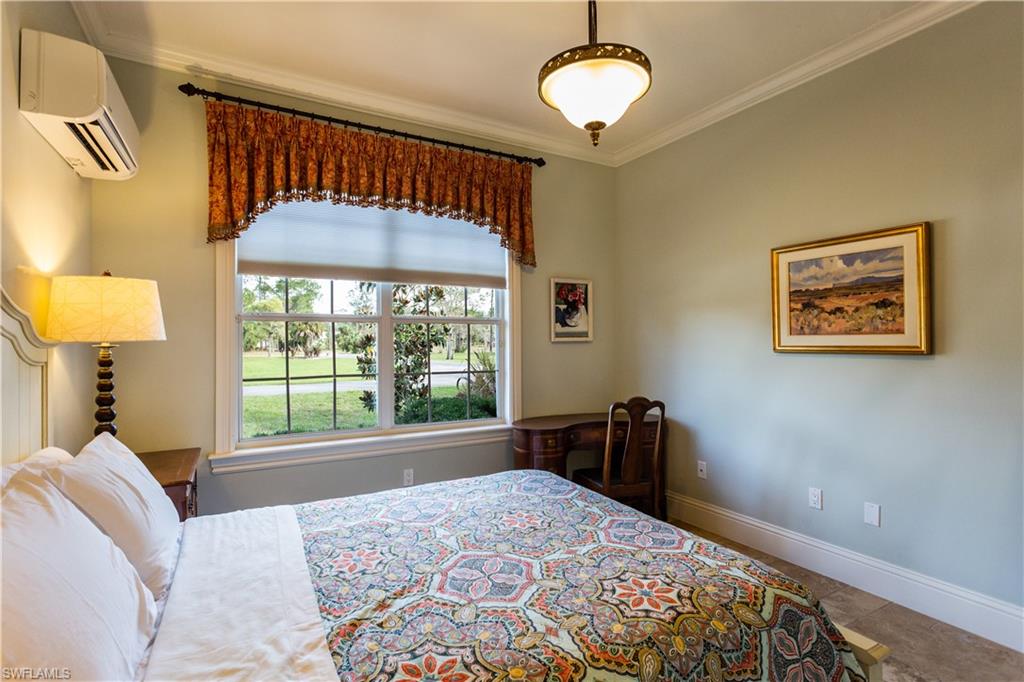 2225 23rd Street Southwest Naples, FL 34117 - Photo 33 of 44 a bedroom with a bed and a dresser next to a window