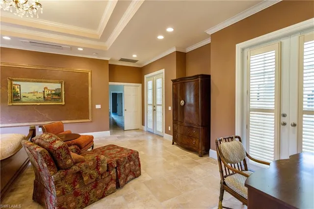 a spacious bedroom with a bed and glass furniture