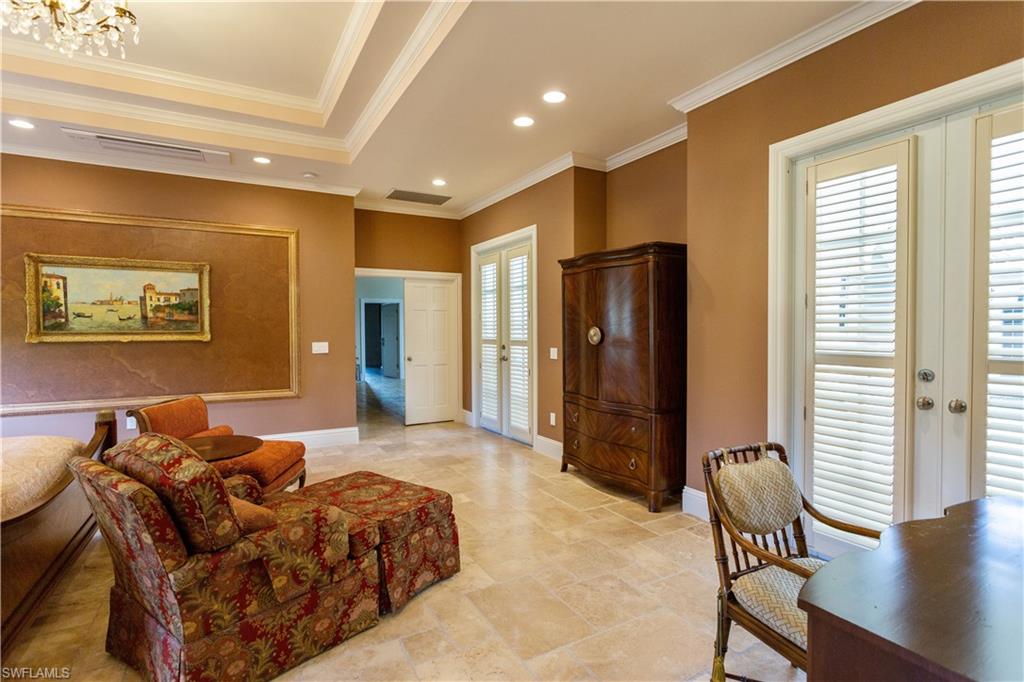 2225 23rd Street Southwest Naples, FL 34117 - Photo 38 of 44 a spacious bedroom with a bed and glass furniture