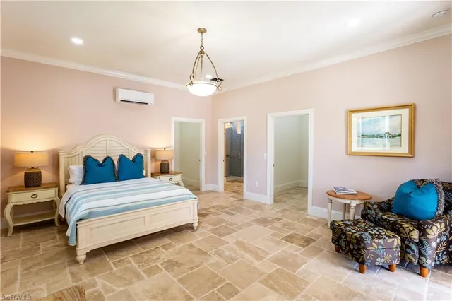 a spacious bedroom with a bed and a chandelier