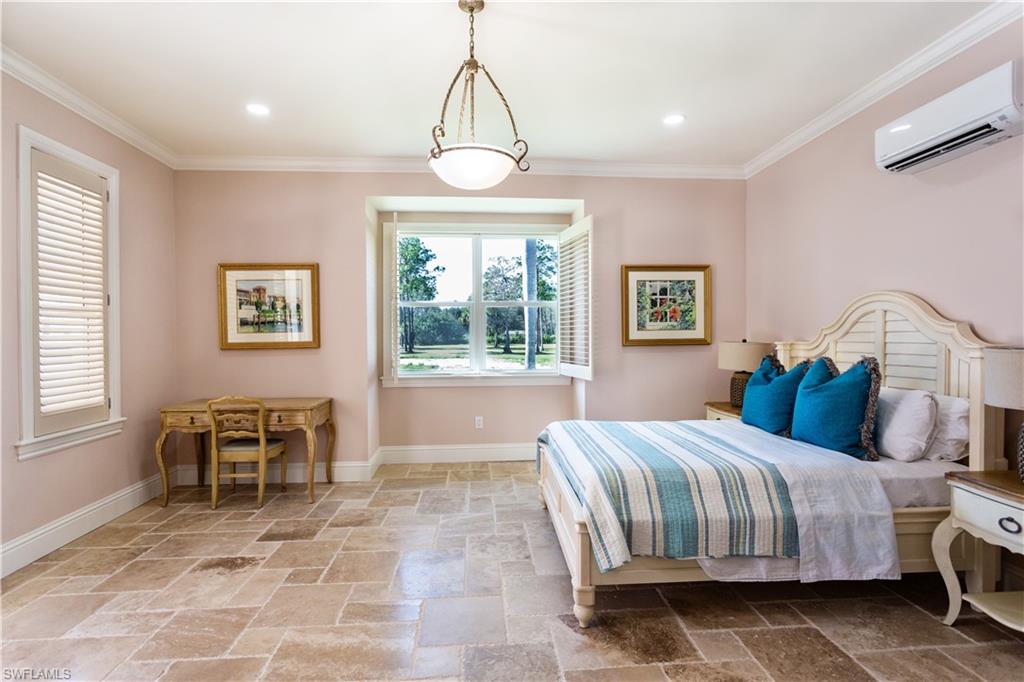 2225 23rd Street Southwest Naples, FL 34117 - Photo 44 of 44 a bedroom with a bed and a chandelier
