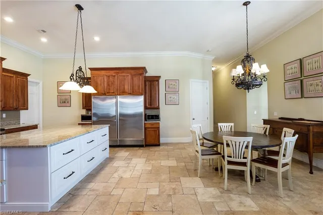 a kitchen with granite countertop cabinets a dining table and chairs