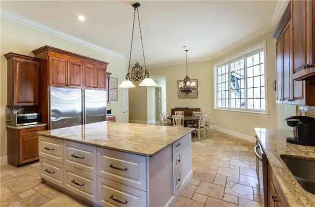 a kitchen with stainless steel appliances granite countertop a sink a stove and a wooden floors