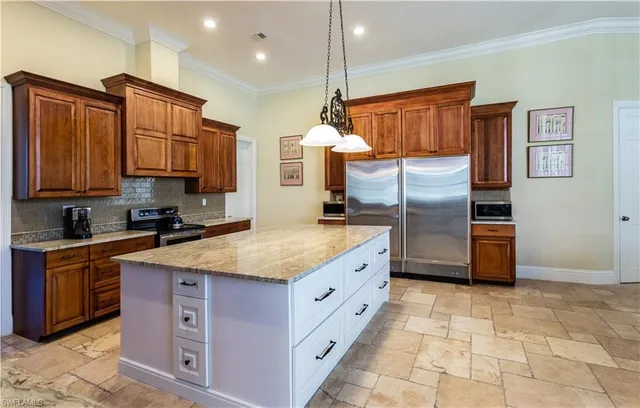 a kitchen with stainless steel appliances granite countertop a sink a stove and a refrigerator