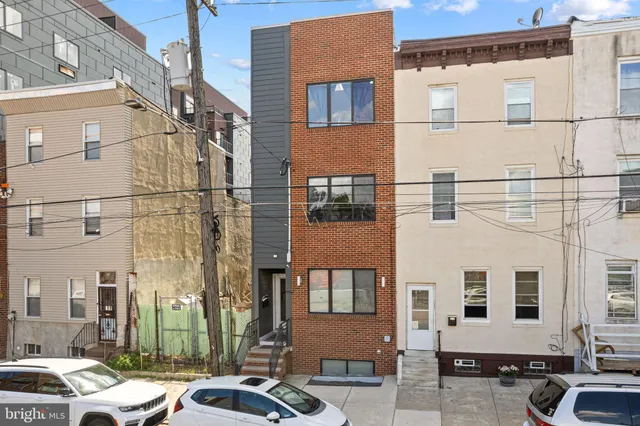 a couple of cars parked in front of a building