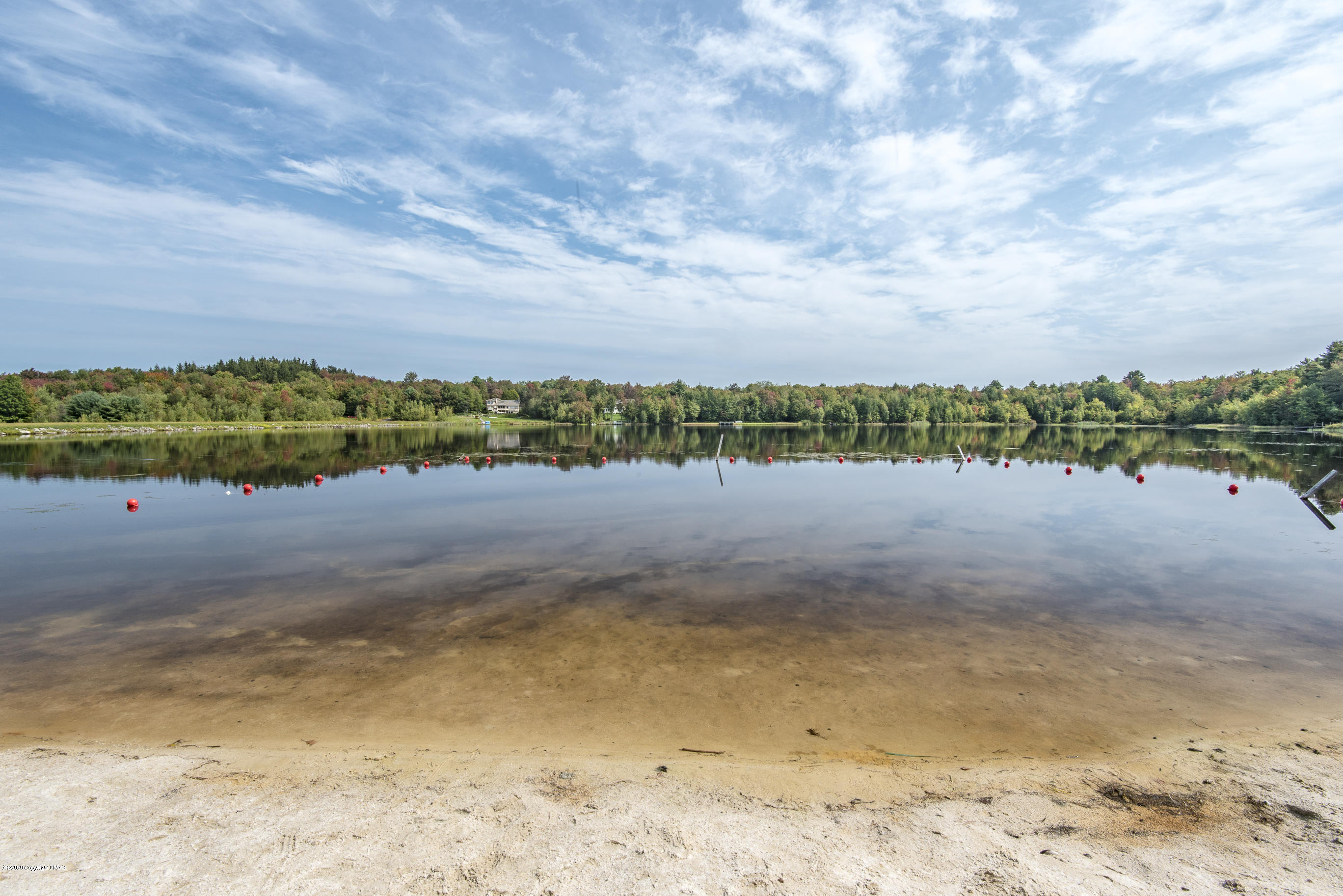 4 Lidio Road Blakeslee, PA 18610 - Photo 16 of 20 a view of a lake with beach and big trees