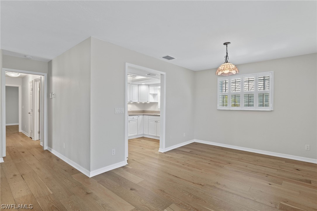 657 Rabbit Road Sanibel, FL 33957 - Photo 20 of 37 a view of an empty room with wooden floor and a window