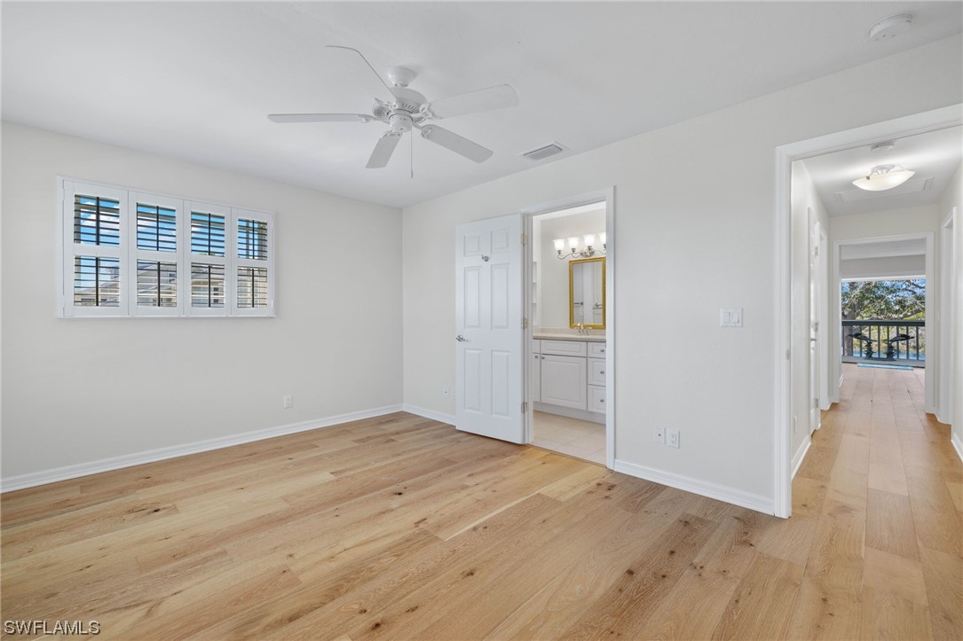 657 Rabbit Road Sanibel, FL 33957 - Photo 21 of 37 a view of an empty room with wooden floor and a window