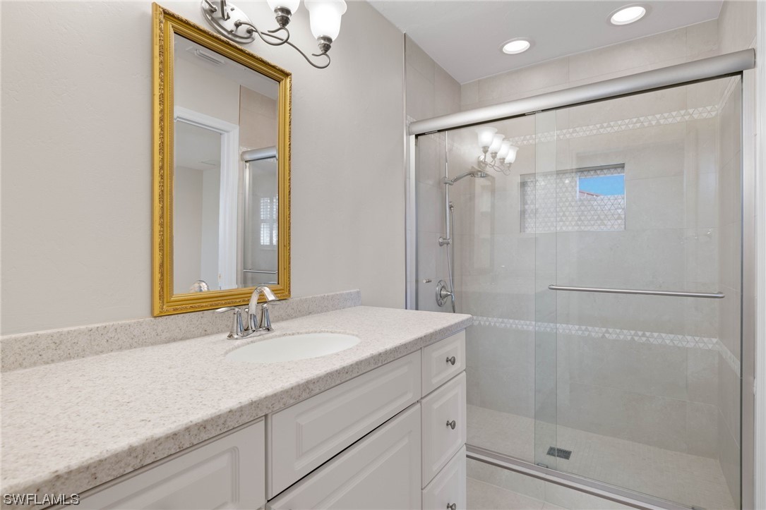 657 Rabbit Road Sanibel, FL 33957 - Photo 23 of 37 a bathroom with a shower sink and mirror