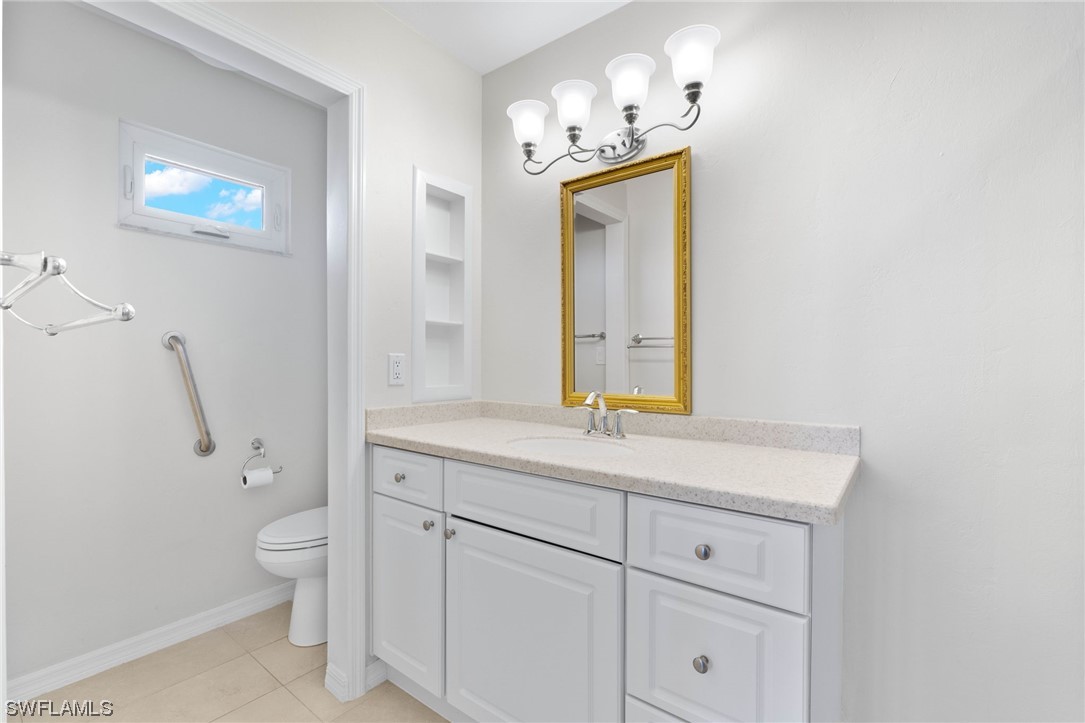657 Rabbit Road Sanibel, FL 33957 - Photo 24 of 37 a bathroom with a sink a toilet and a mirror