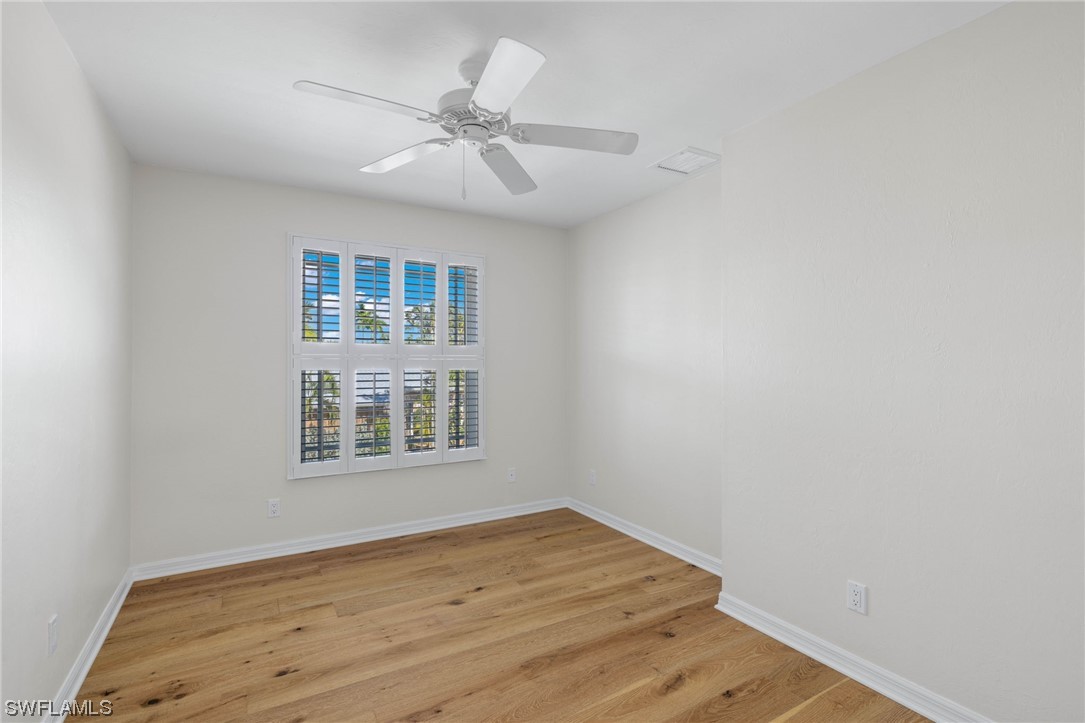 657 Rabbit Road Sanibel, FL 33957 - Photo 25 of 37 wooden floor in an empty room with a window
