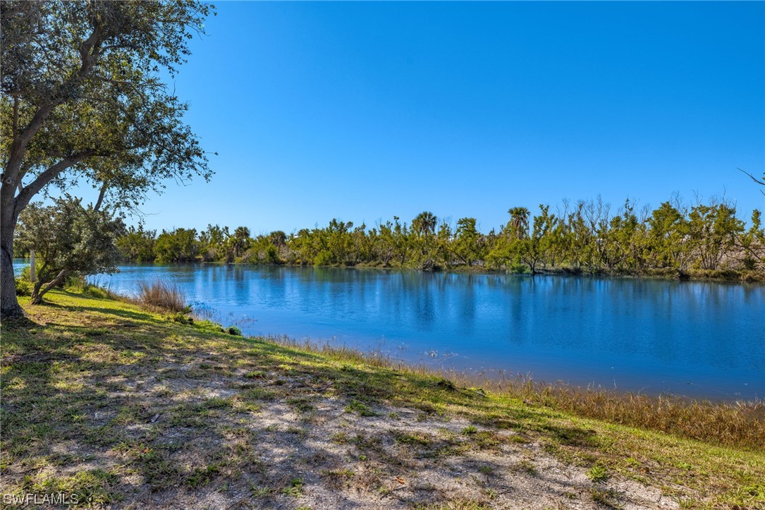 657 Rabbit Road Sanibel, FL 33957 - Photo 3 of 37 a view of a lake with houses in the back