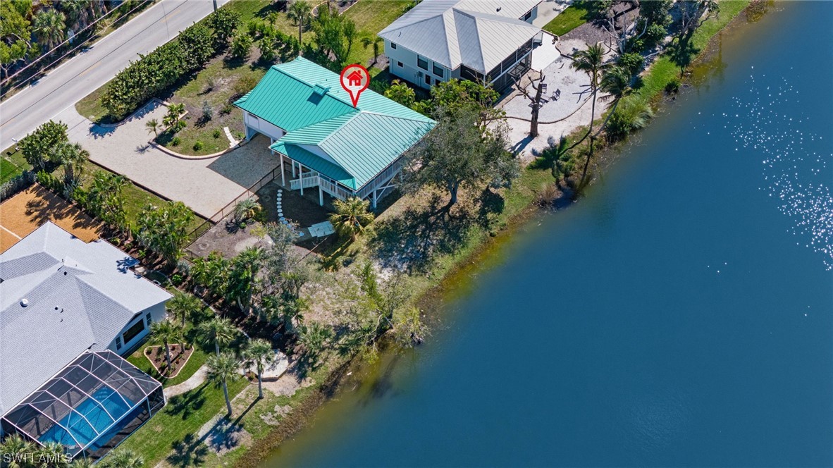 657 Rabbit Road Sanibel, FL 33957 - Photo 33 of 37 an aerial view of a house lake swimming pool outdoor seating and yard