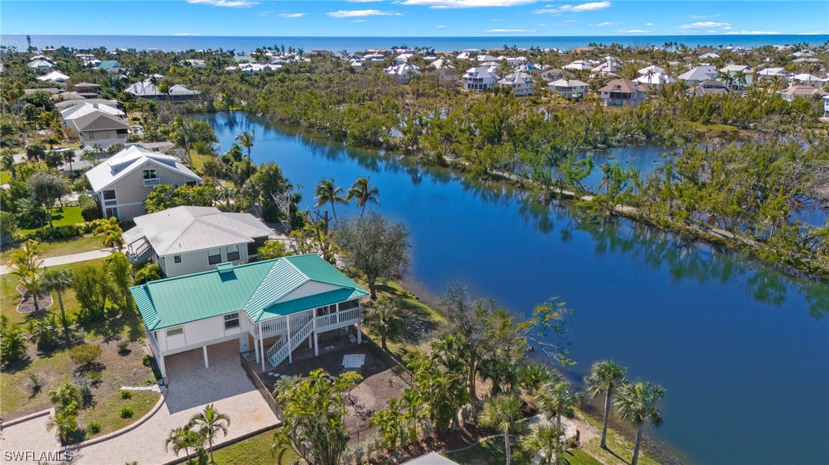 657 Rabbit Road Sanibel, FL 33957 - Photo 34 of 37 an aerial view of a house with a lake view