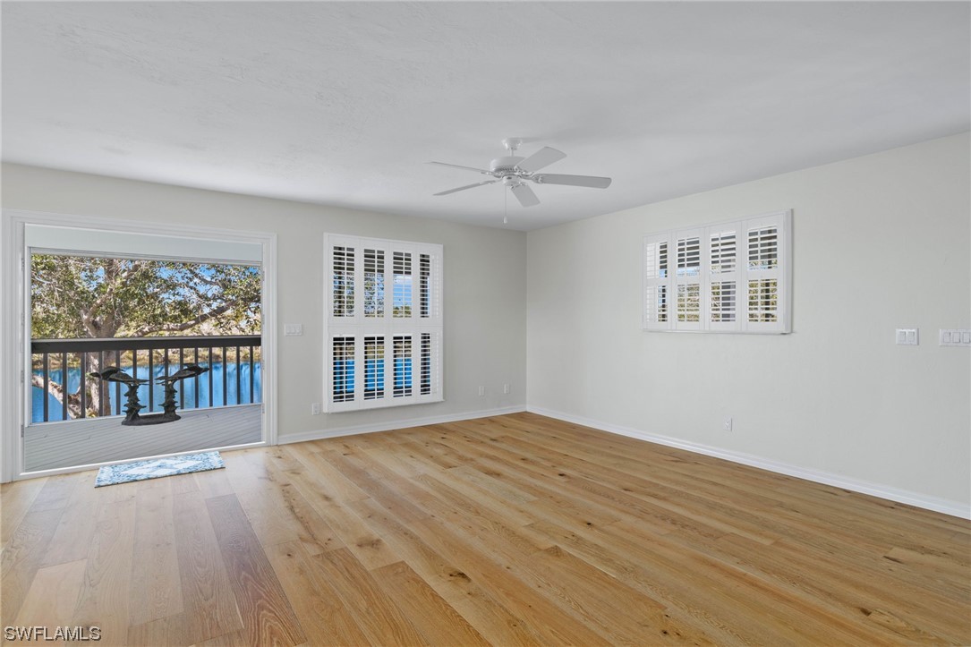 657 Rabbit Road Sanibel, FL 33957 - Photo 5 of 37 a view of an empty room with a window and wooden floor