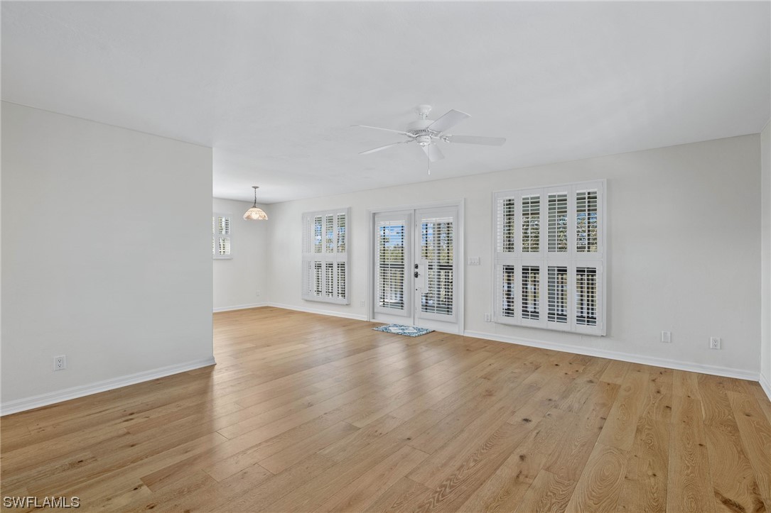 657 Rabbit Road Sanibel, FL 33957 - Photo 6 of 37 a view of an empty room with wooden floor and a window