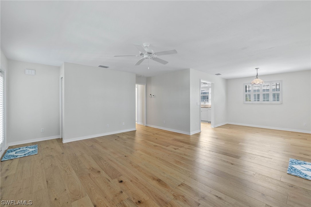 657 Rabbit Road Sanibel, FL 33957 - Photo 8 of 37 a view of an empty room with wooden floor and a ceiling fan