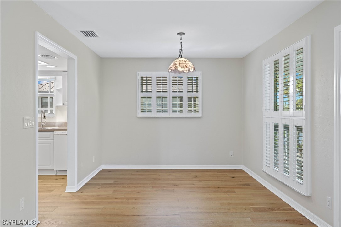 657 Rabbit Road Sanibel, FL 33957 - Photo 9 of 37 a view of an empty room with wooden floor and a window