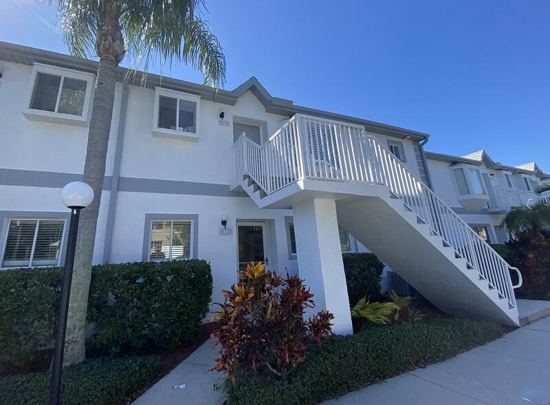 343 Ocean Park Lane, Unit V110 Cape Canaveral, FL 32920 - Photo 1 of 25 a front view of a house with garden