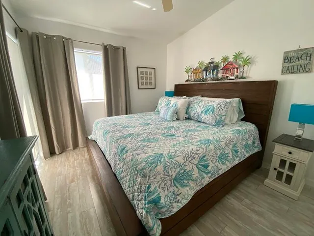 a large bed sitting in a bedroom next to a window